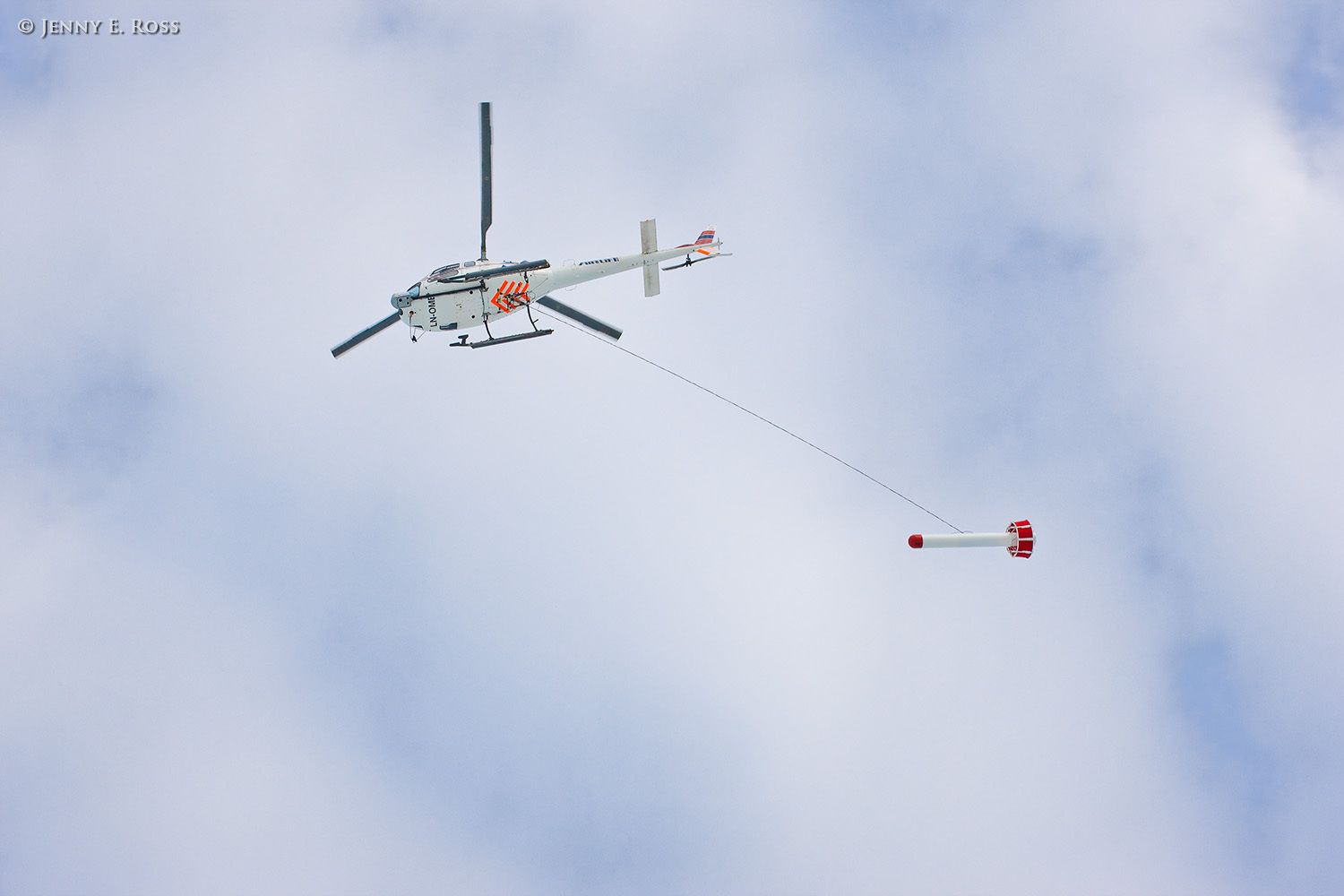 During a research expedition n the Arctic Ocean, Norwegian Polar Institute scientists assess sea ice thickness using an airborne instrument called the EM-Bird, a large torpedo-shaped scientific devicethat hangs from a helicopter. As the helicopter flies transects above the sea ice, the electromagnetic and laser sensors in the EM-Bird collect data that can then used to calculate the thickness of the ice. This work was conducted near 82.5-degrees North / 21-degrees East as part of NPI's 2012 "ICE" (Ice, Climate, and Ecosystems) expedition in July-August 2012. Scientific research on arctic sea ice, central polar basin, Arctic Ocean