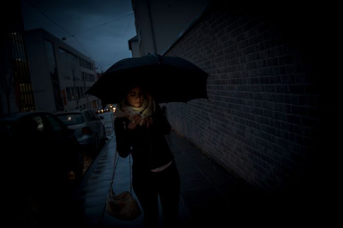 Sarah walks along a street in the evening in a German town where she moved after being released from Islamic State (IS) captivity in Iraq
