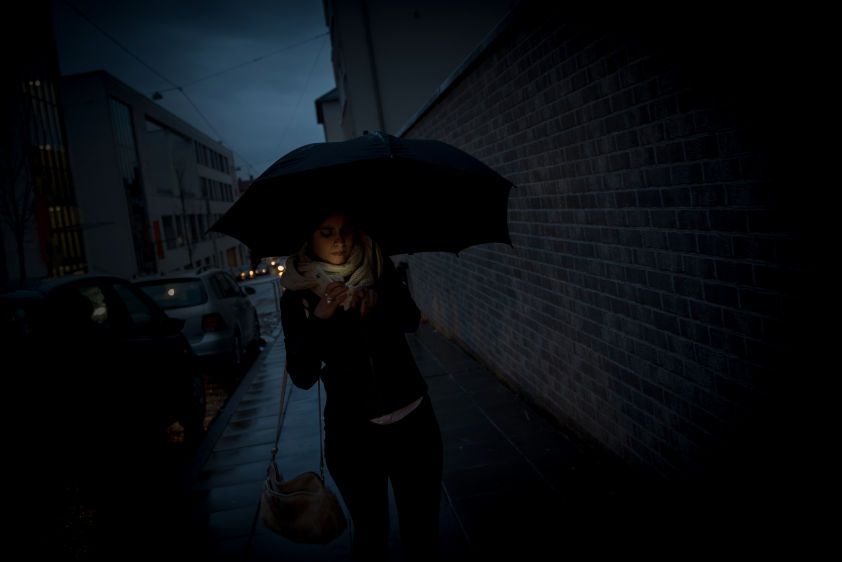 Sarah walks along a street in the evening in a German town where she moved after being released from Islamic State (IS) captivity in Iraq