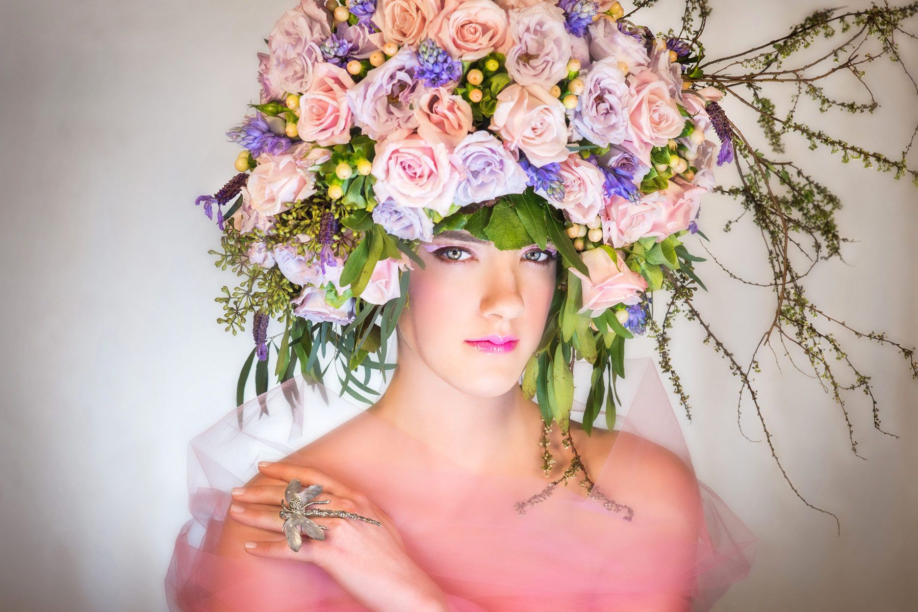 Fashion model wearing a pastel floral headdress.  In studio Photo Shoot.