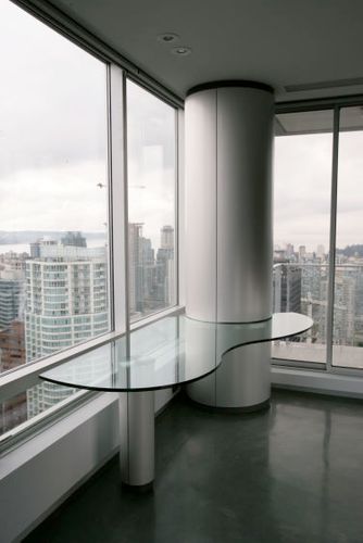 MILLWORK DESK Project# 533Shaped Glass Work SurfaceMetal Laminate Columns Around Cement Pillar & Desk Support Post