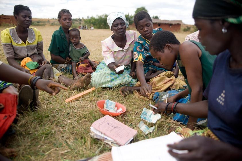 Meetings start by counting the money. The secretary asks for loan payments. Savings are collected - each person has 5 shares with 10 percent interest. Loans are requested but can not exceed more than there is in savings. VSL Group Meeting