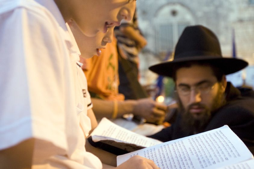 Settlers adhere to a conservative, even orthodox lifestyle.  Here, settler males sing from the Torah. 1pal_sttlrrlly_05_04