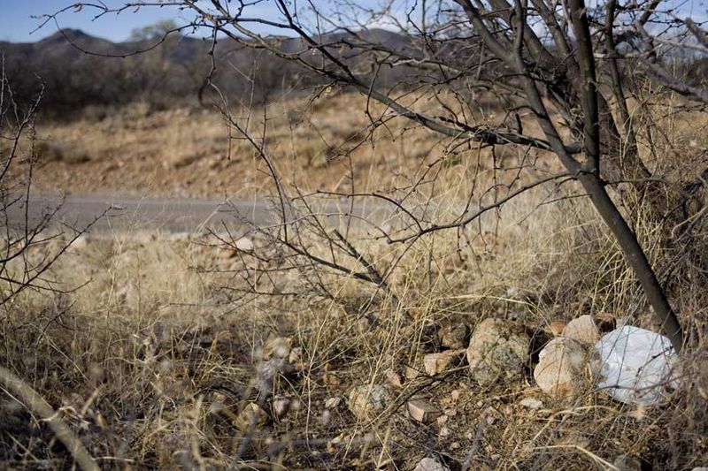 A discarded water jug by the road was likely left by a migrant in hiding, waiting for a pick up after the long desert journey. Waiting