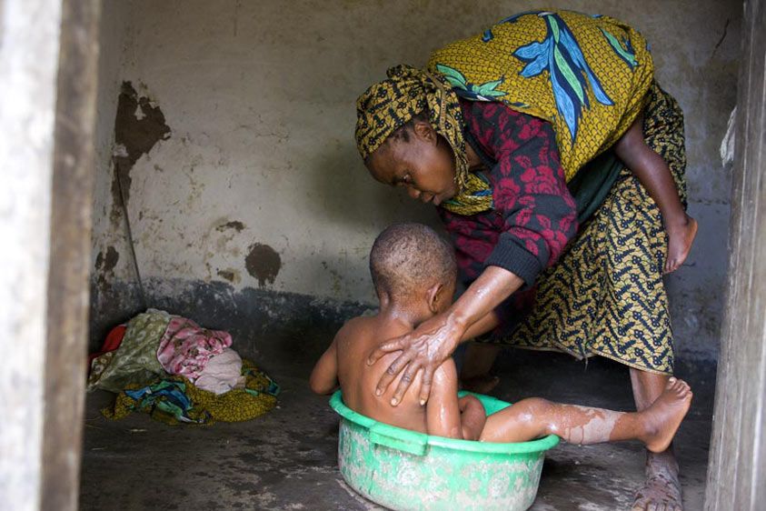 Women are responsible for household needs as well as maintaining their VSL activities. Elise cares for two of her grandchildren. A grandmother's work