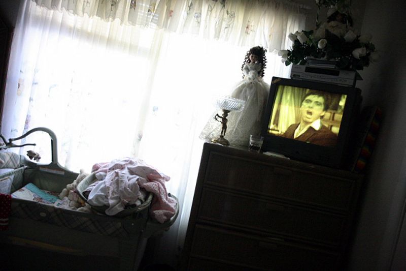 The movie 'Scarface' plays near the baby's crib. The American Way