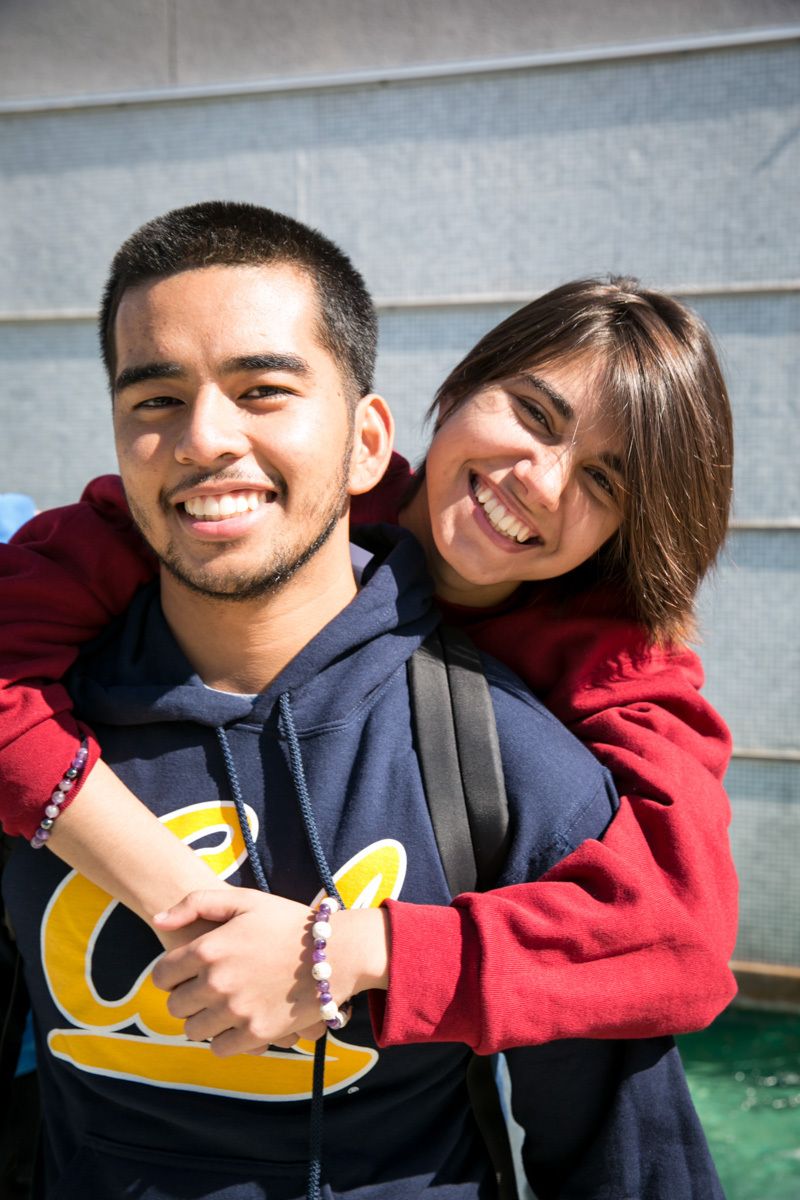 Male and female student on campus