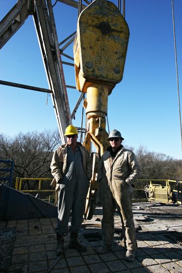 Workers on a natural gas rig platform
