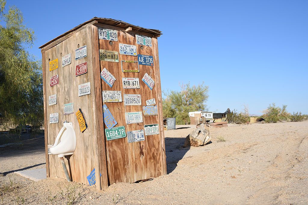 Slab City outhouse, with variety of statehood license plate ornamentations