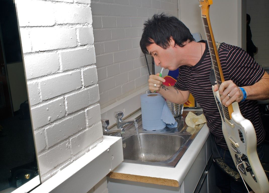 Johnny Marr cleans his teeth.