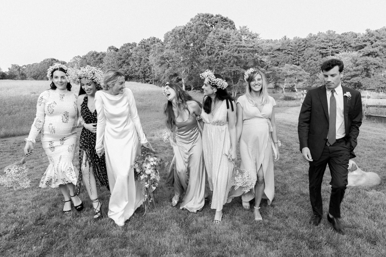 Bride party walking and laughing in a garden