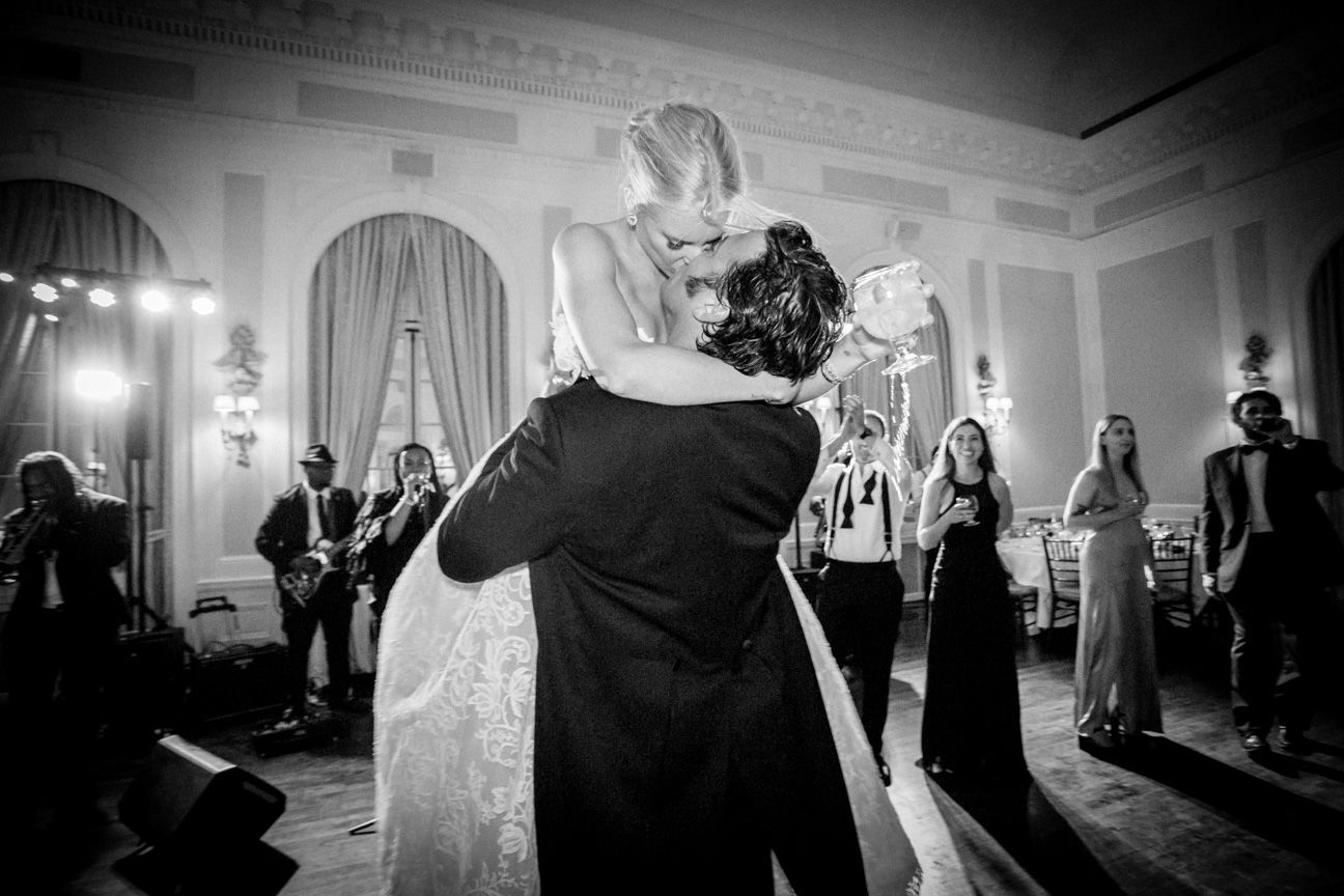 View Fine Art Portfolios Bride and groom kiss and hug at their reception