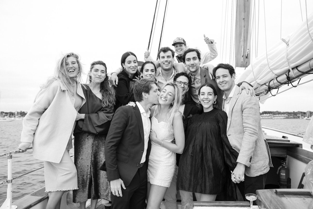 Wedding party on a sail boat smiling