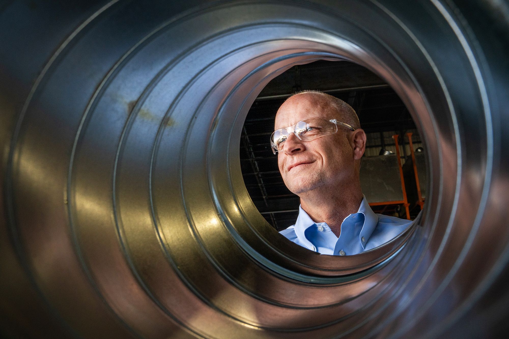 Jeffrey Sprau, CEO,Therma Holdings LLC, is photographed through a duct manufactured in their facility in San Jose.