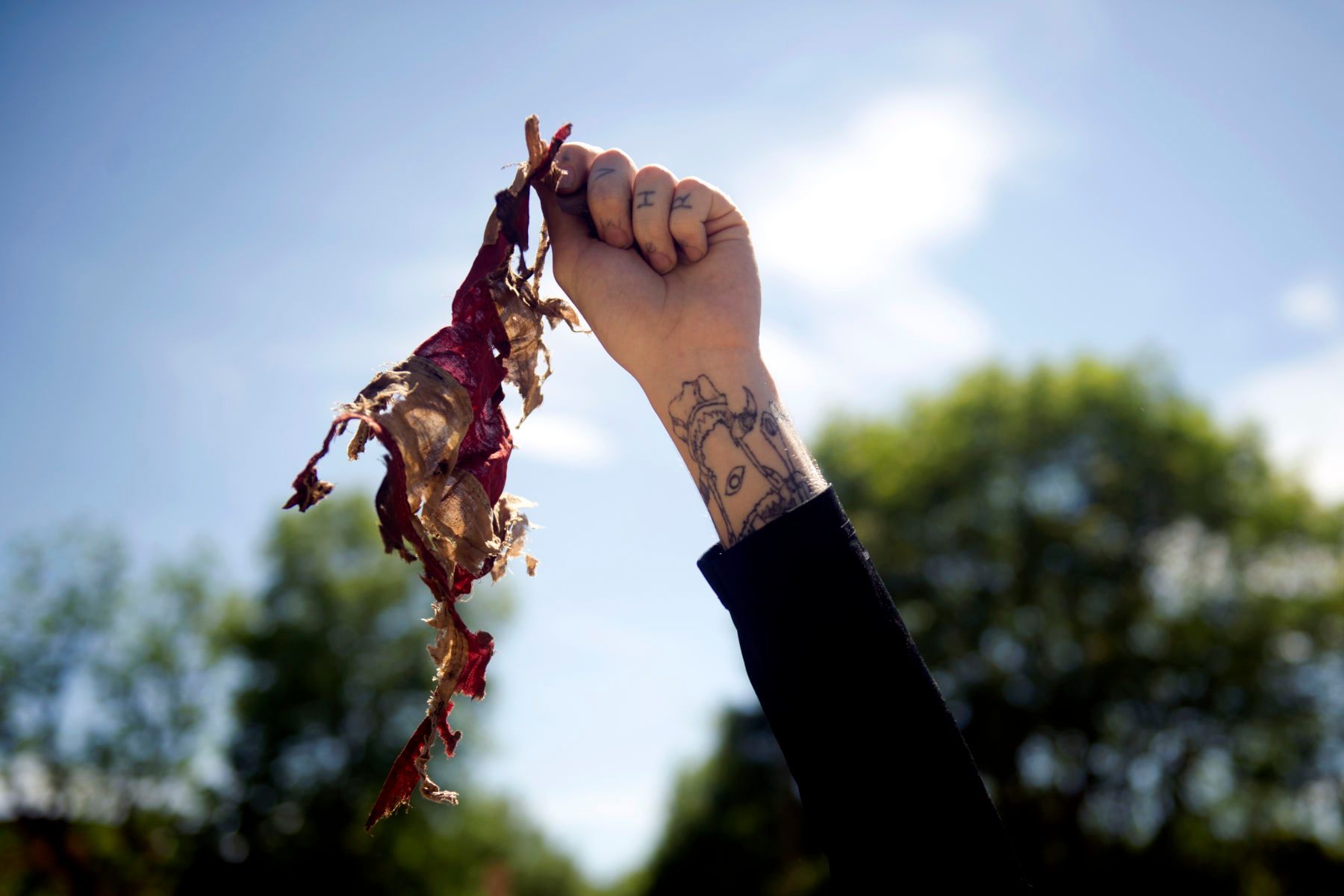 An Antifa demonstrator holds up the remains of a tattered and burned U.S. flag during the Denver March Against Sharia Law in Denver, Colorado on June 10, 2017. The march was supported by two right-wing groups, The Proud Boys, and Bikers Against Radical Islam, and opposed by anti-Trump demonstrators and Antifa members. Police kept the counter protestors separated during the rally which was held in front of the Colorado State Capital. The march was one of many held throughout the U.S. opposing Sharia law, and was viewed by many as promoting both Islamophobia and racism. 1march_against_sharia_law_denver151