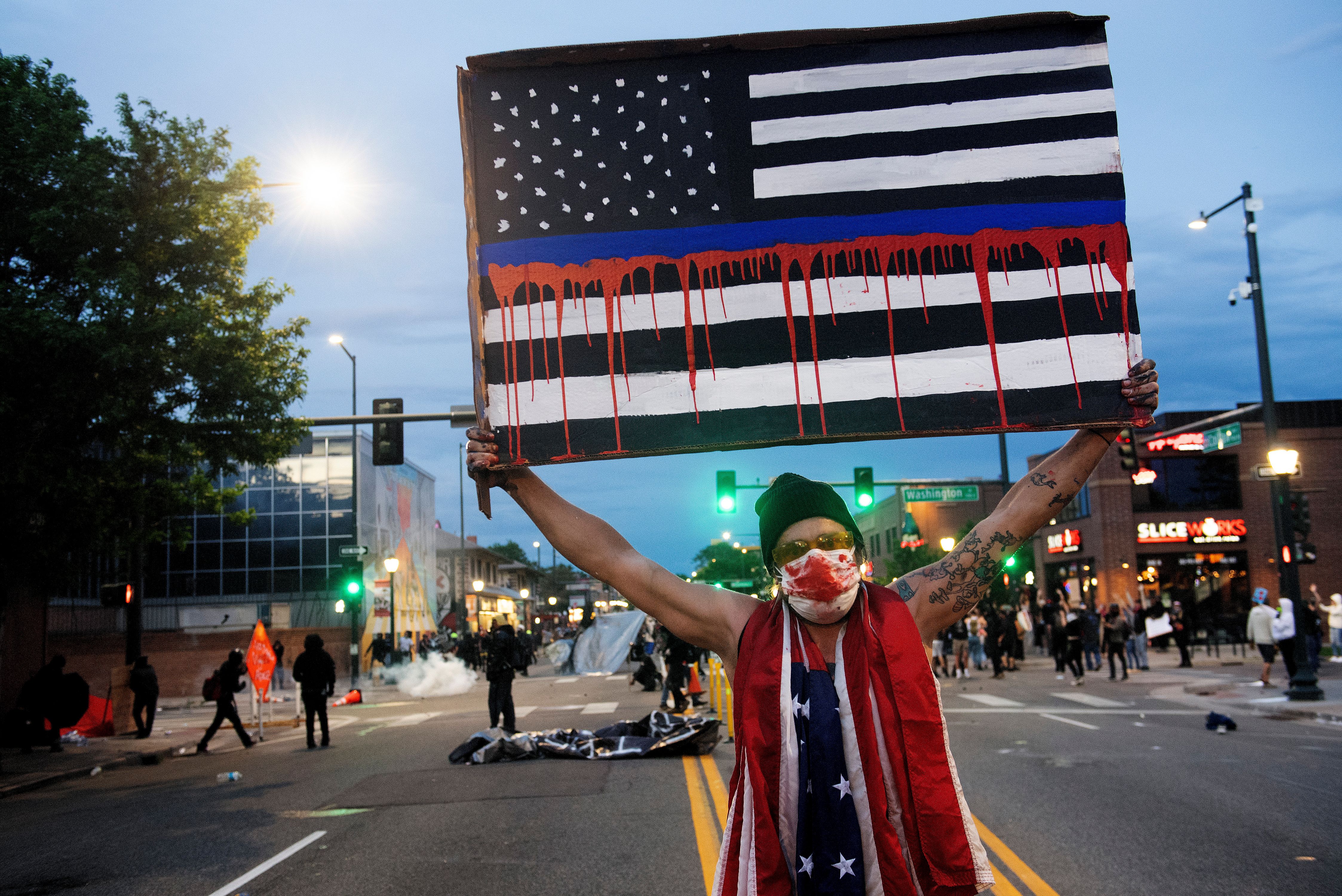 A demonstrator holds up a sign during a protest in Denver, Colorado, on May 31, 2020, over the death of George Floyd, an unarmed black man who died while while being arrested and pinned to the ground by the knee of a Minneapolis police officer.  George Floyd- Denver 05-31-20770.jpg