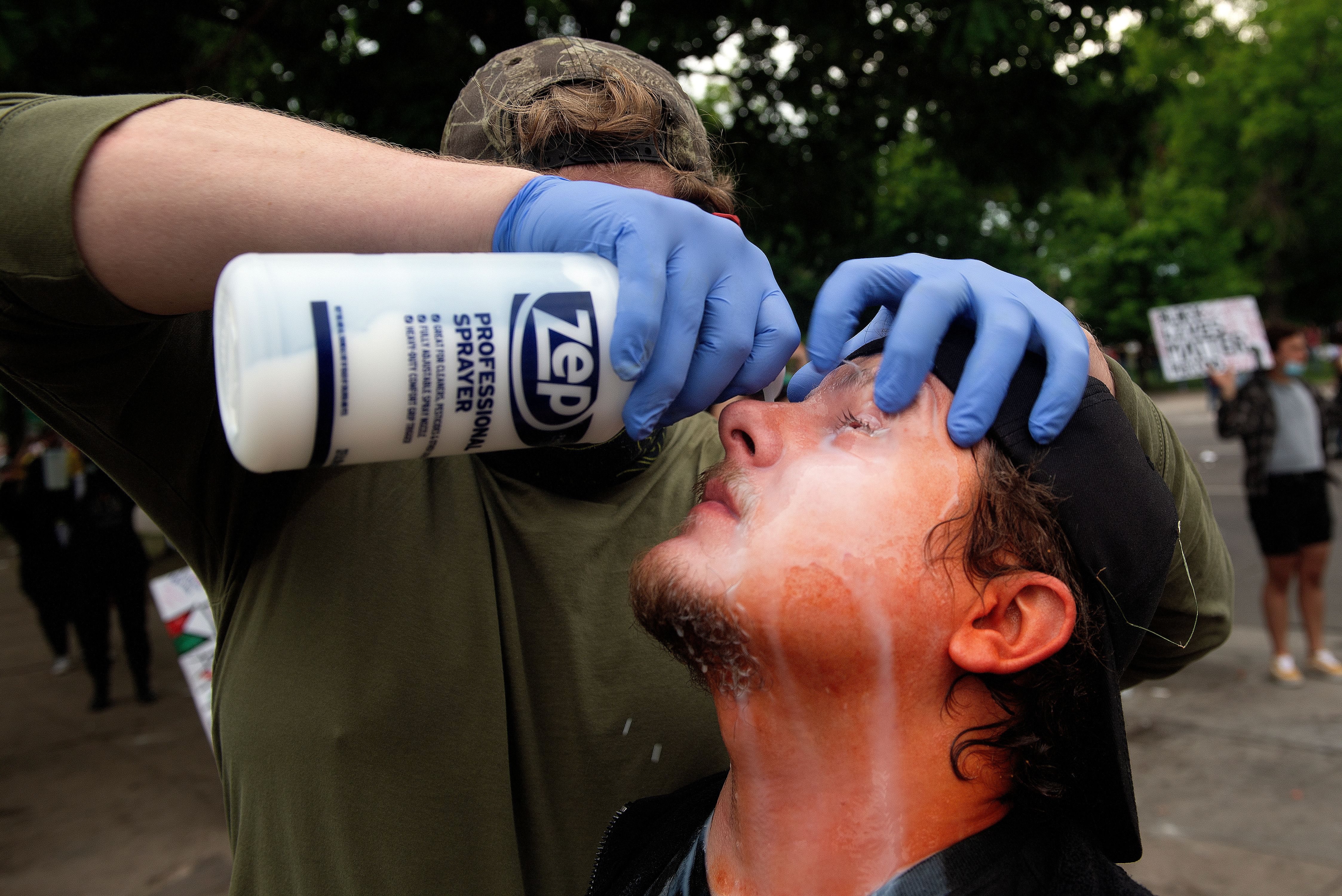 A demonstrator gets his eyes washed after being hit by pepper spray in Denver, Colorado on May 30, 2020 while protesting the death of George Floyd, an unarmed black man who died while while being arrested and pinned to the ground by the knee of a Minneapolis police officer.  Denver-George Floyd Protest44.jpg