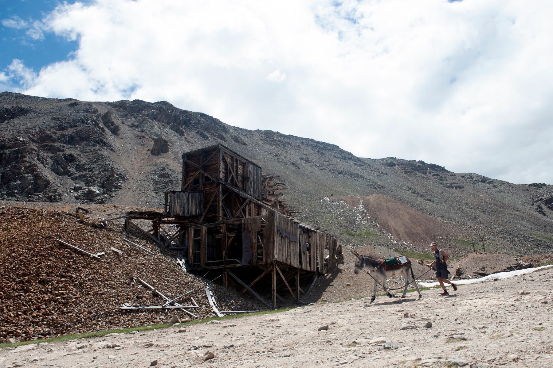 Kirt Courkamp of Pine, Colorado and his burro Mary Margaret run past the North London Mine after racing over Mosquito Pass during the 69th Annual Burro Days Pack Burro Race in Fairplay, Colorado on July 30, 2017.  1burro_days_2017315seqn_