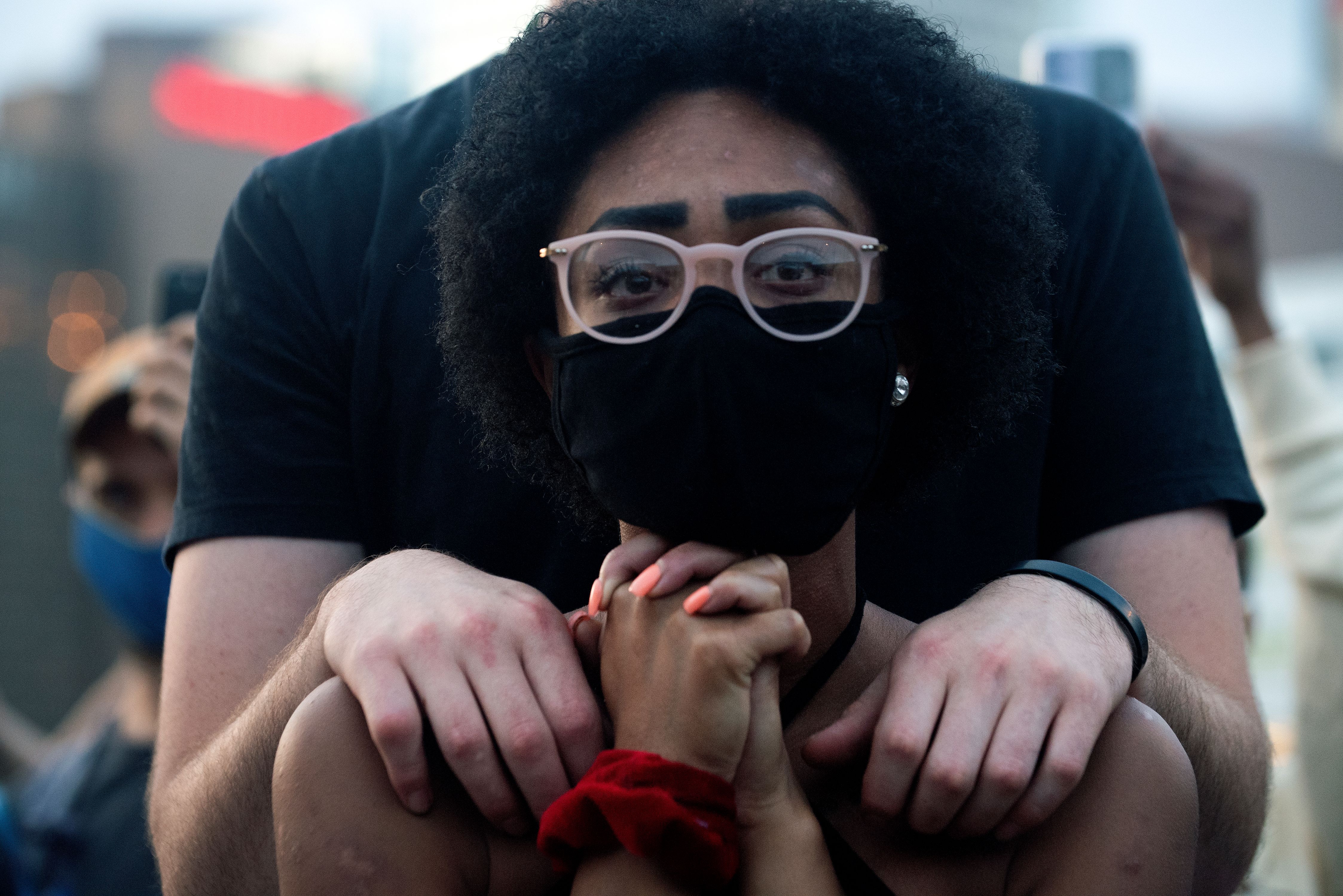 Sayanna Robinson (C) is embraced by Jonah Charnick (not seen), while protesting the death of George Floyd, an unarmed black man who died while while being arrested and pinned to the ground by the knee of a Minneapolis police officer, at Civic Center Park in Denver, Colorado on June 3, 2020. Denver-GeorgeFloyd1014.1.jpg