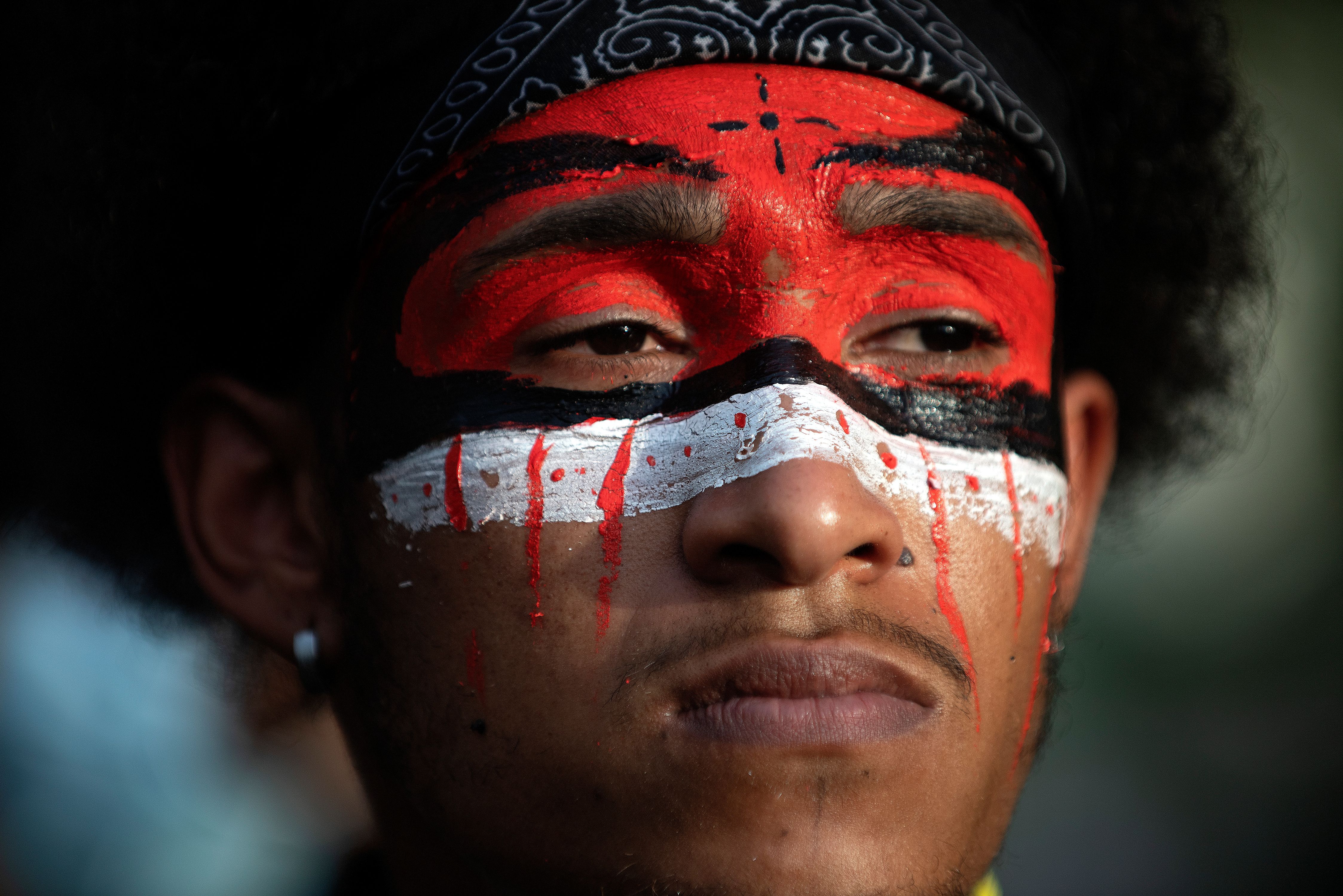 A demonstrator with a painted face in honor of his various ethnicities is seen in Denver, Colorado, on May 31, 2020, over the death of George Floyd, an unarmed black man who died while while being arrested and pinned to the ground by the knee of a Minneapolis police officer.  George Floyd- Denver 05-31-20238.jpg