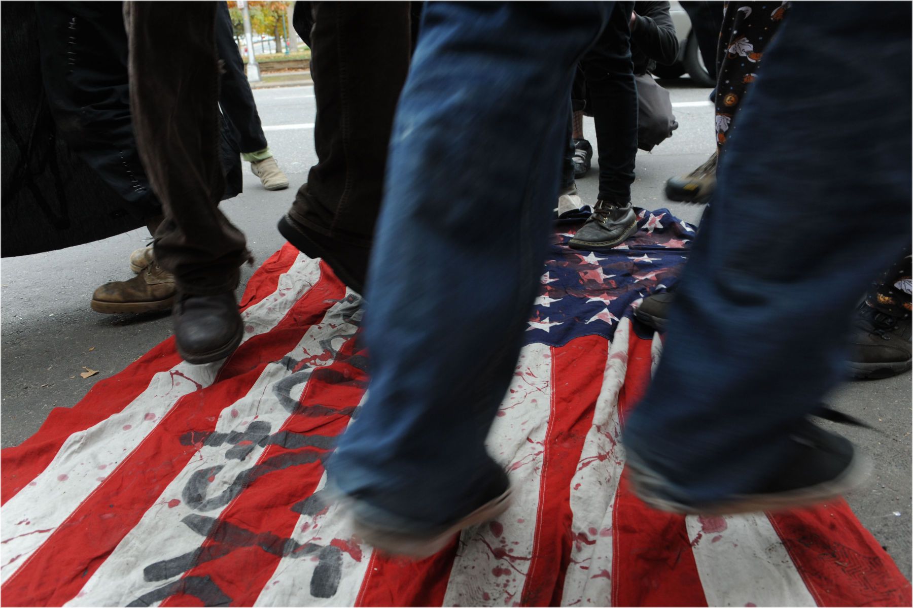 Demonstrators dance on the American flag in the middle of Broadway in Denver, Colorado. 1jumpb