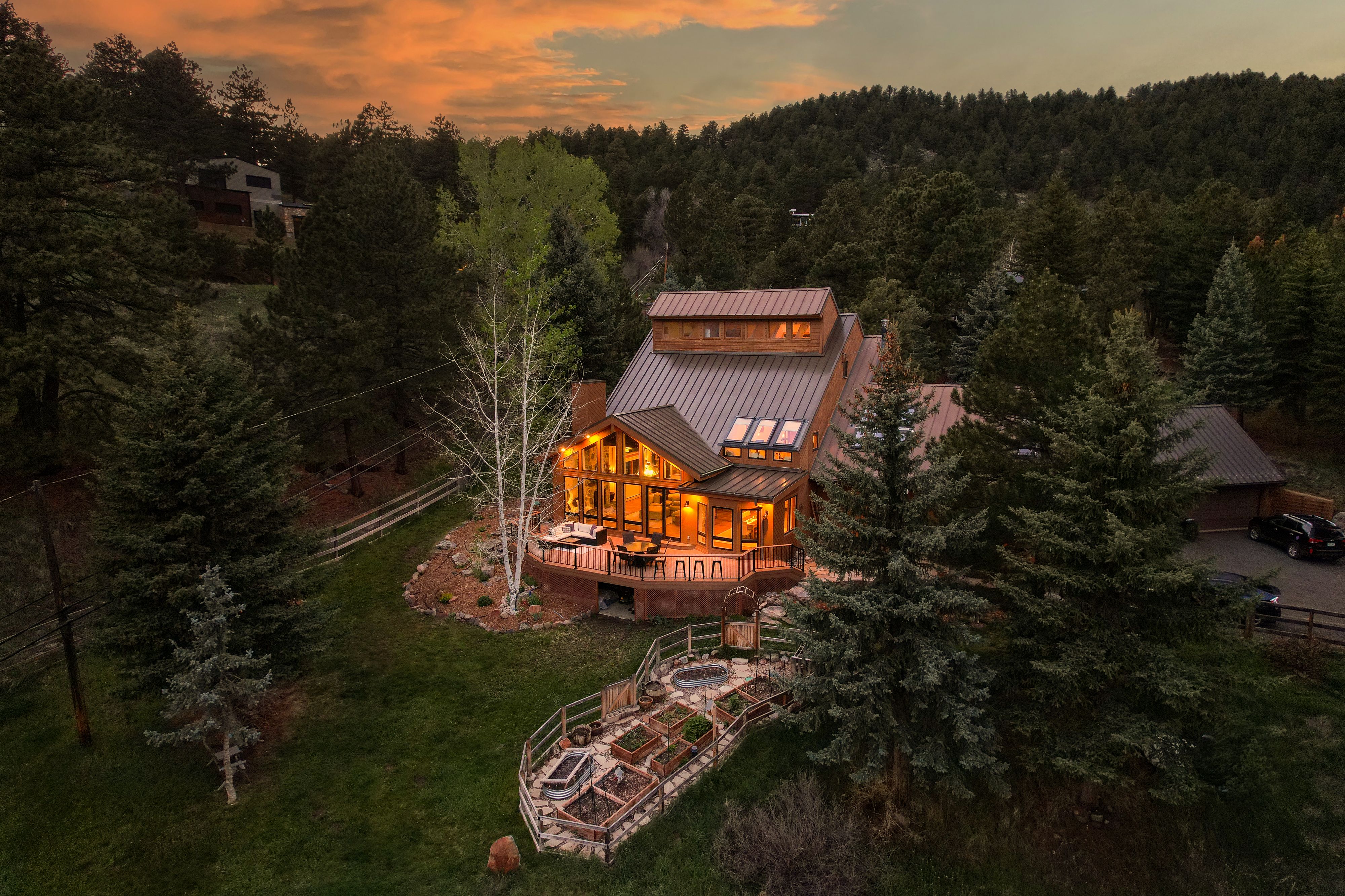 An drone twighlight real estate photo of a country home. Twighlight real estate photography with the lights of the home and dark skies can set an inviting mood. Twilight Glowing Home