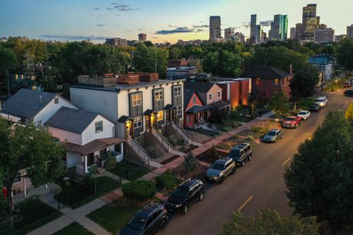 A twighlight drone photo of the Five Points neighborhood, with Denver Downtown in the background. Twighlight Lights in Five Points, Denver, CO.