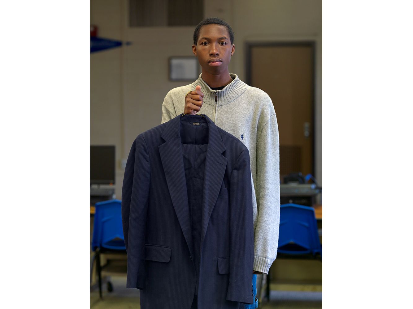 An annual free suit giveaway sponsored by the Covenant House Academy of Southwest Detroit. Hundreds of brand new suits were donated by local retailers for men who need a suit for job interviews, special occasions, or just looking sharp. Young Man Who Received a Free Suit, Westside, Detroit 2014