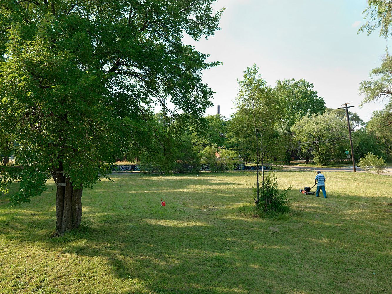 Jose' Mowing a Field, Crawford St., Delray, Detroit 2011