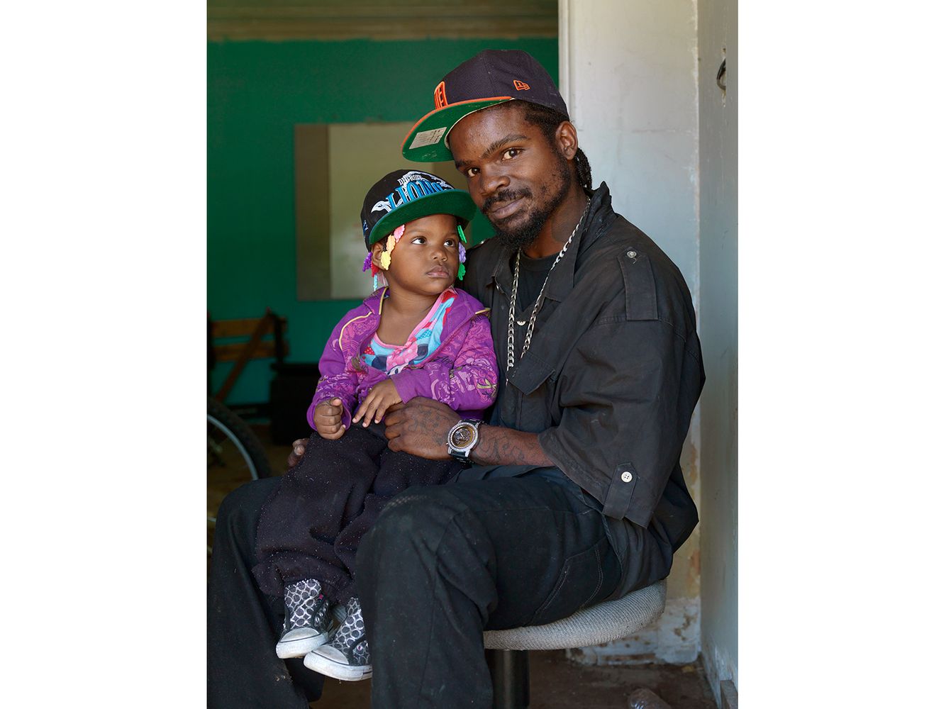 Easy is trying to renovate an abandoned storefront on the corner of Woodward Avenue and Goldengate Street where he wants to open up a bike shop. Called "Smoke's Bike Shop", it will be a haven for neighborhood kids to learn about building and maintaining their bicycles as well as a place for social gatherings. Easy with His Daughter Emeliah, Goldengate Street, Detroit 2013