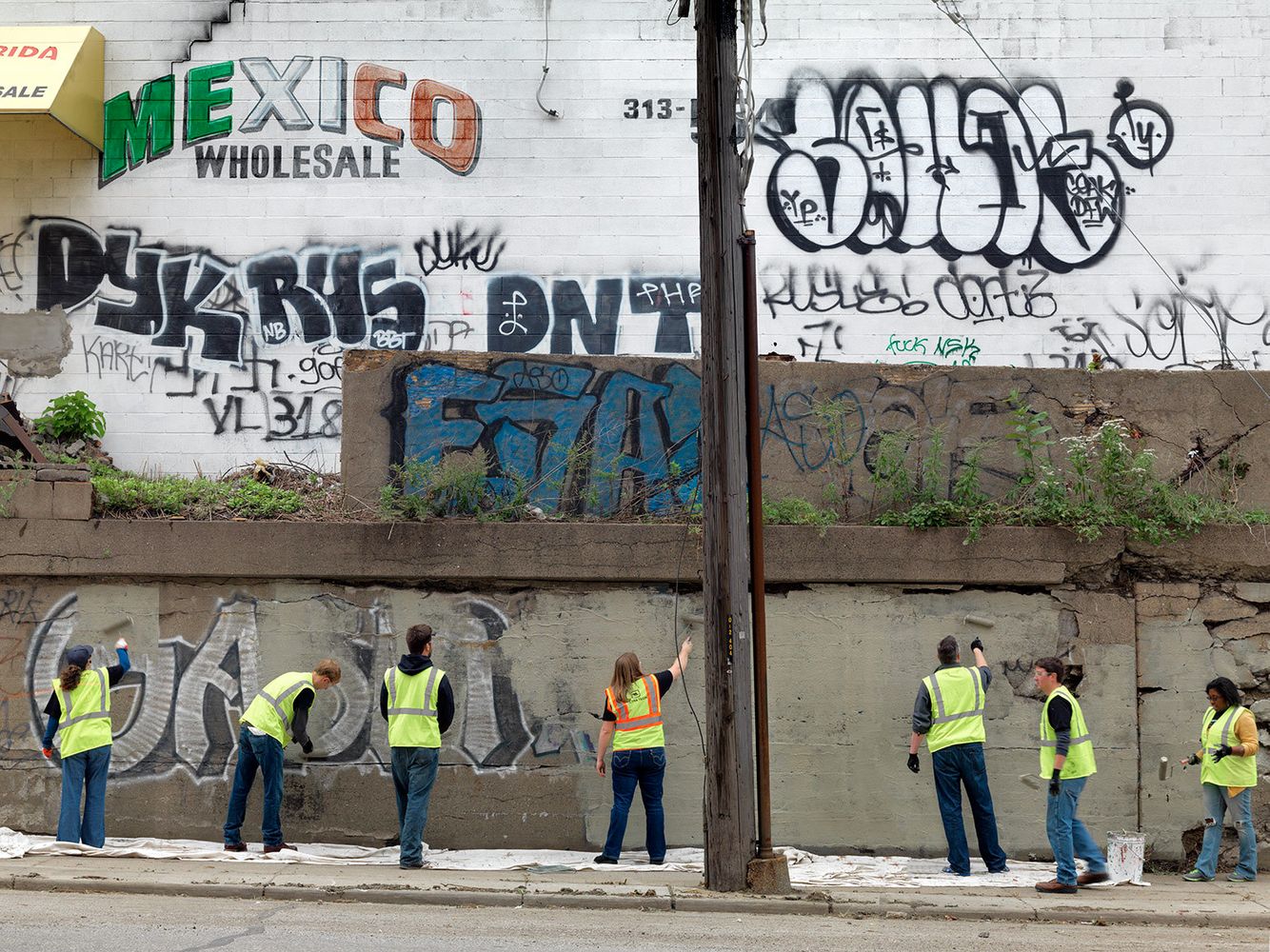 A group of volunteer's who either work for or are contract employees of General Motors clean up a stretch of Junction Avenue where children walk to go to school. Volunteer Clean-Up Crew, Southwest Side, Detroit 2014