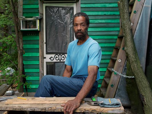 Tom Sitting in Front of His One Room Cabin, Southwest Side, Detroit 2014