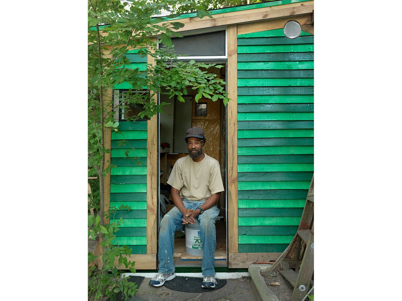 Tom Sitting in the Doorway of His New One-Room Cabin, Near Westside, Detroit  2011