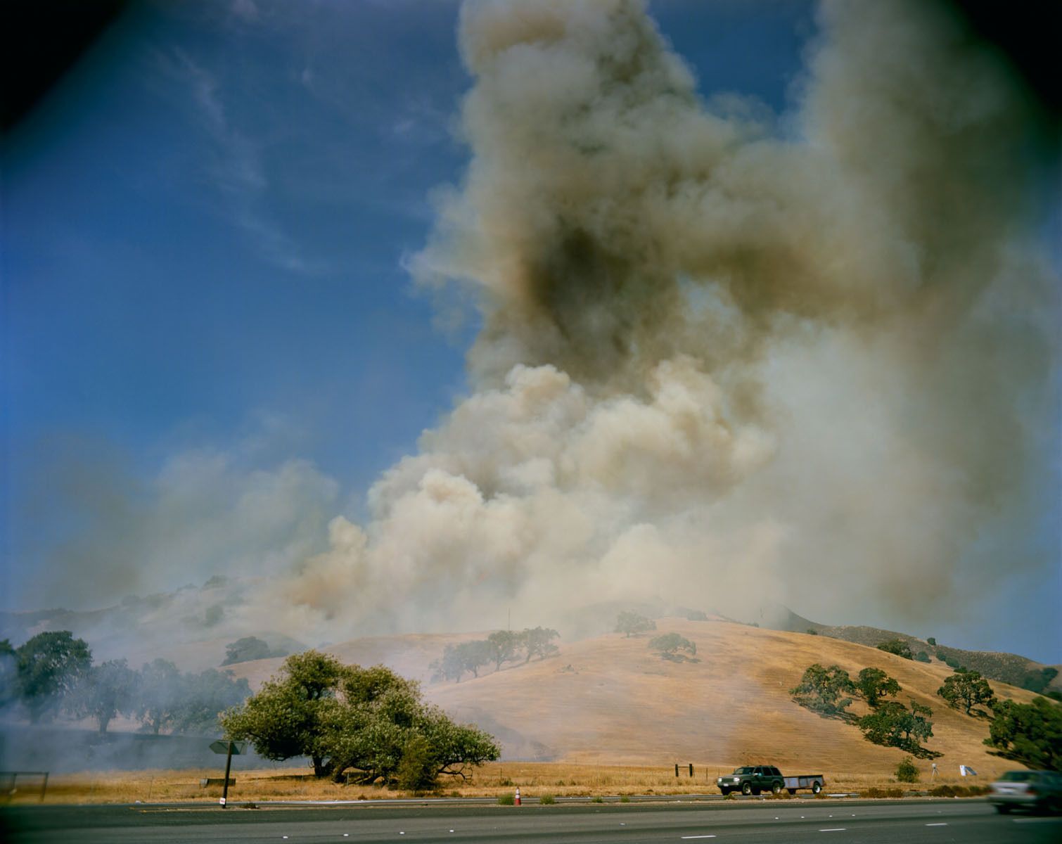 Originally I was heading down Route 101 to go into another fire with media access, but in the distance subtle signs of smoke could be seen over the hills nearing the road to Los Banos. The fire started when a car accident caused flames to quickly spread through the bone-dry hills and only upon arrival did it actually erupt as I was setting up my camera. 2009 Pacheco Fire, West of Los Banos, California