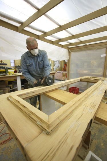 Door restoration by Winchester Woodworking craftsman, inside of dust containment shelter, historic Eastern Market