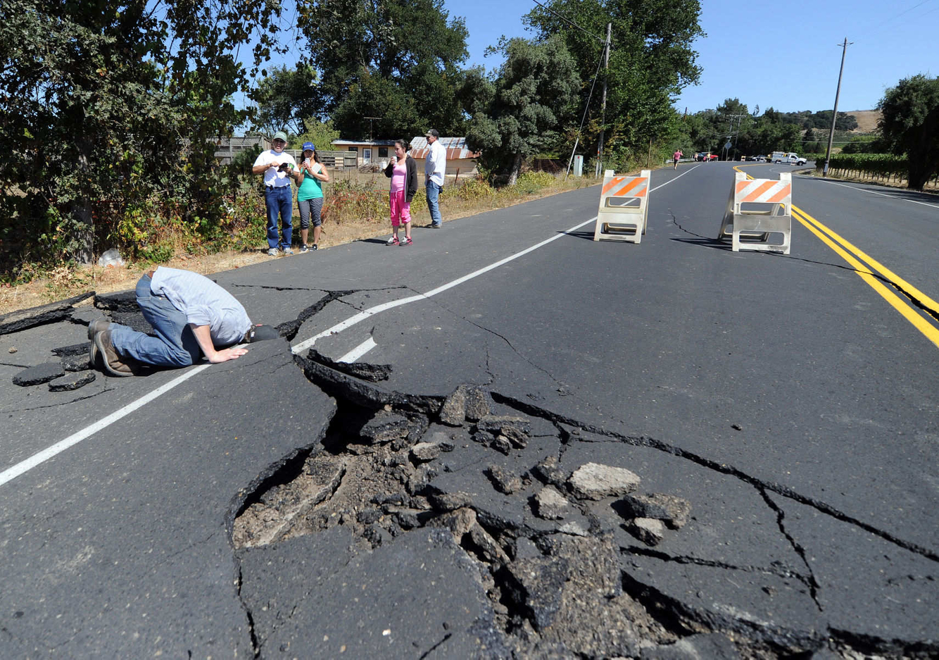 EARTHQUAKE: Nicholas George looks under a buckled highway