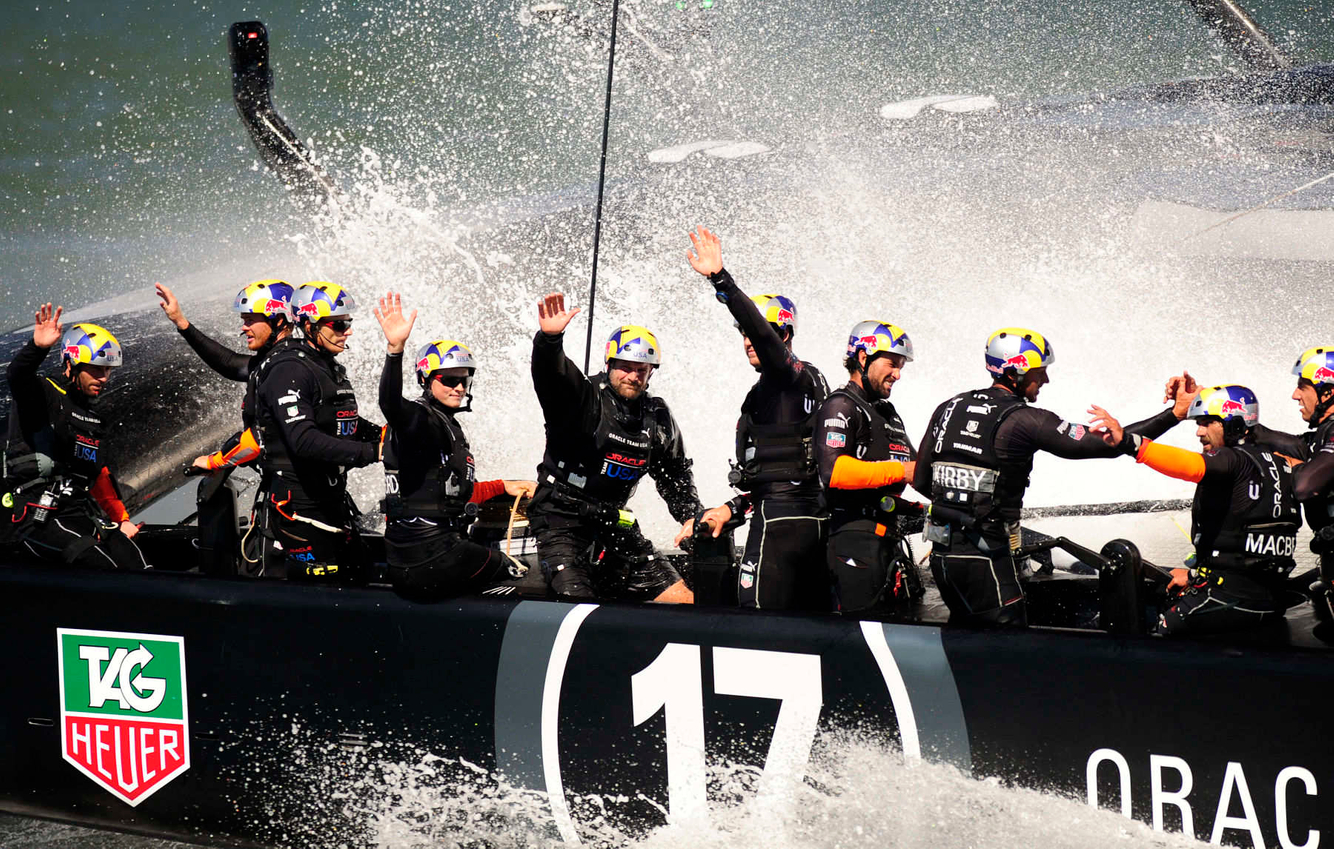 Oracle Team USA waves to spectators after winning race 16