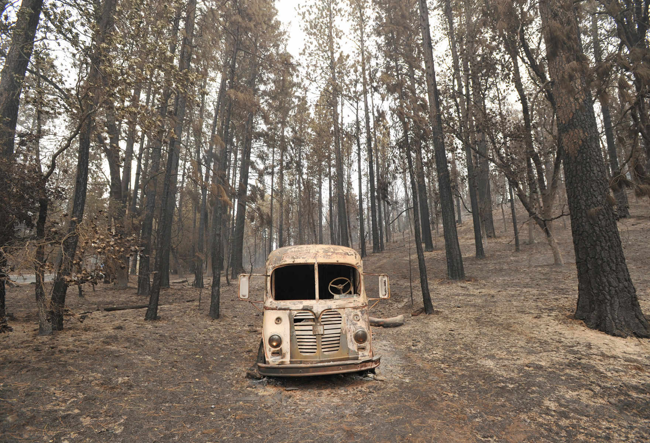 An abandoned burned out truck remains in a residential neighborhood after the Valley fire tore through the area.