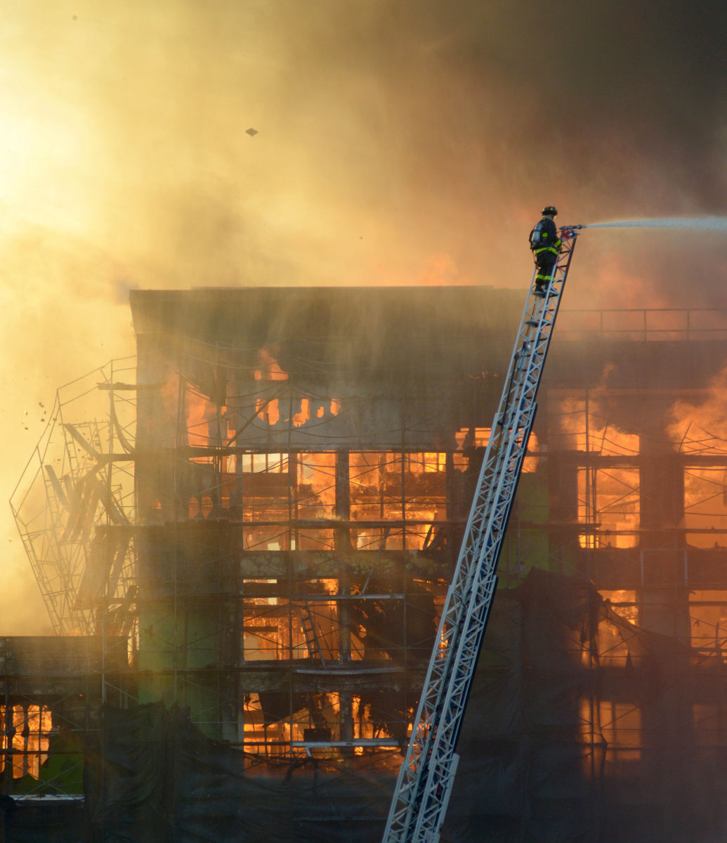 FIRE: A building crumbles as flames overtake a construction site in San Francisco.