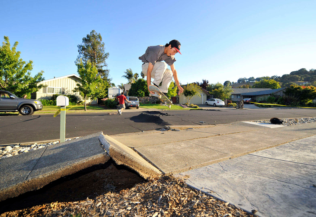 EARTHQUAKE: A skateboarder launches over a buckled sidewalk after a 6.1 Earthquake struck in Napa, California.