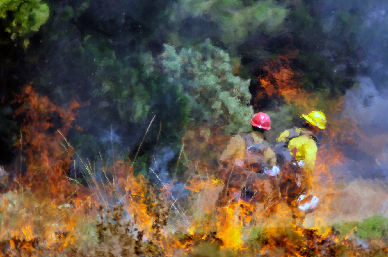 Firefighters are seen through heat