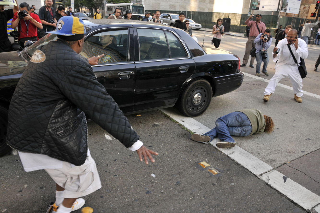 OCCUPY PROTEST: An Oakland Police vehicle backs over a deaf protester while retreating during an Occupy riot