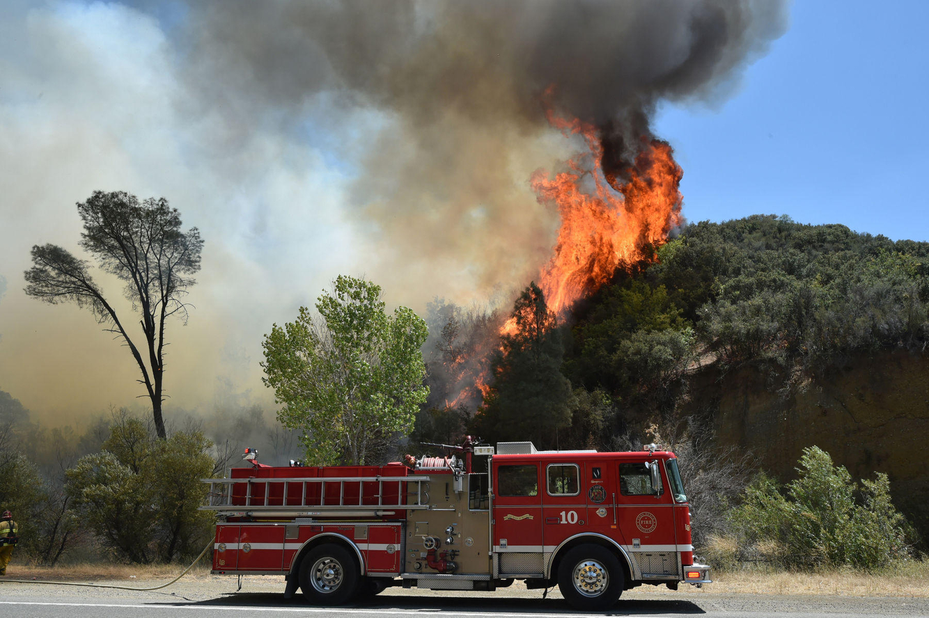 Flames rise above a firetruck