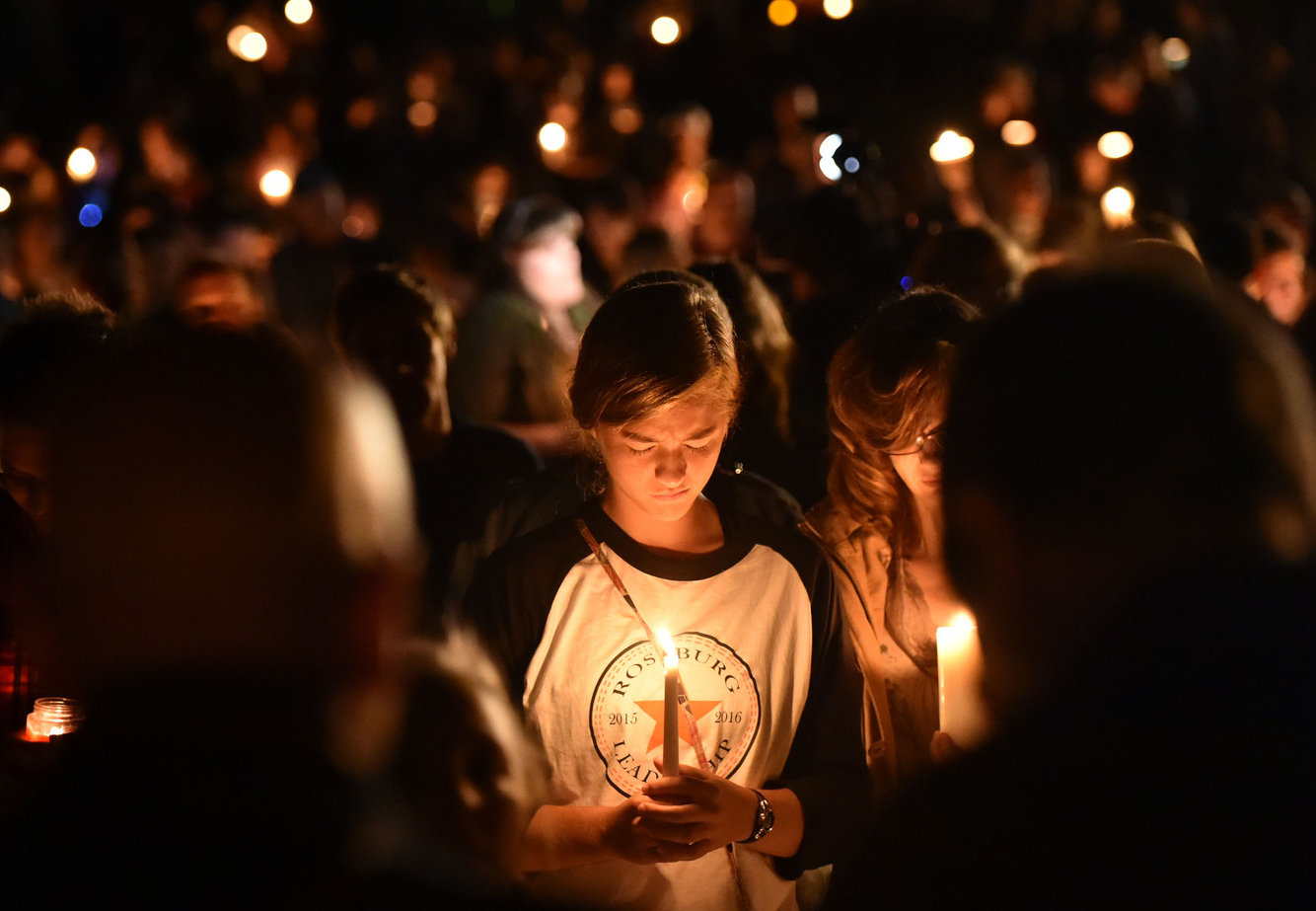 MASS SHOOTING: A girl weeps during a vigil for victims killed in Roseberg, Oregon