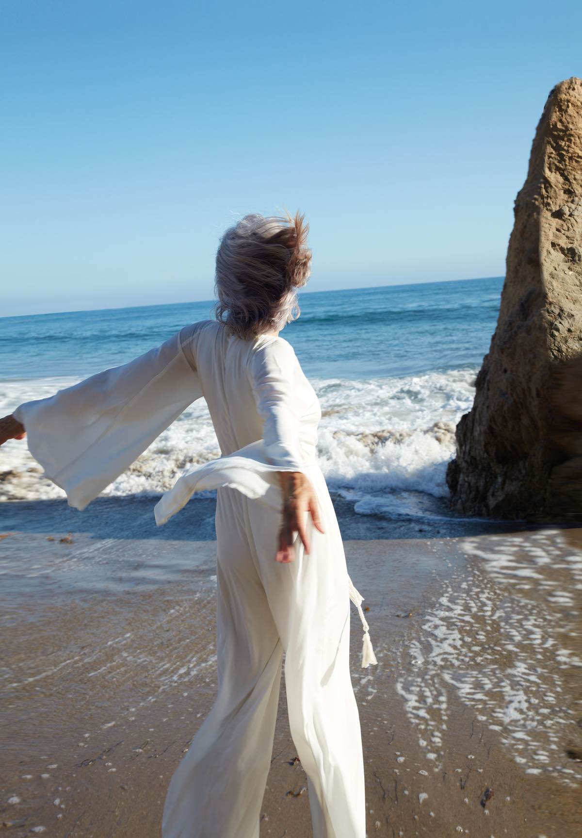 Mature woman enjoying the elements on a beach