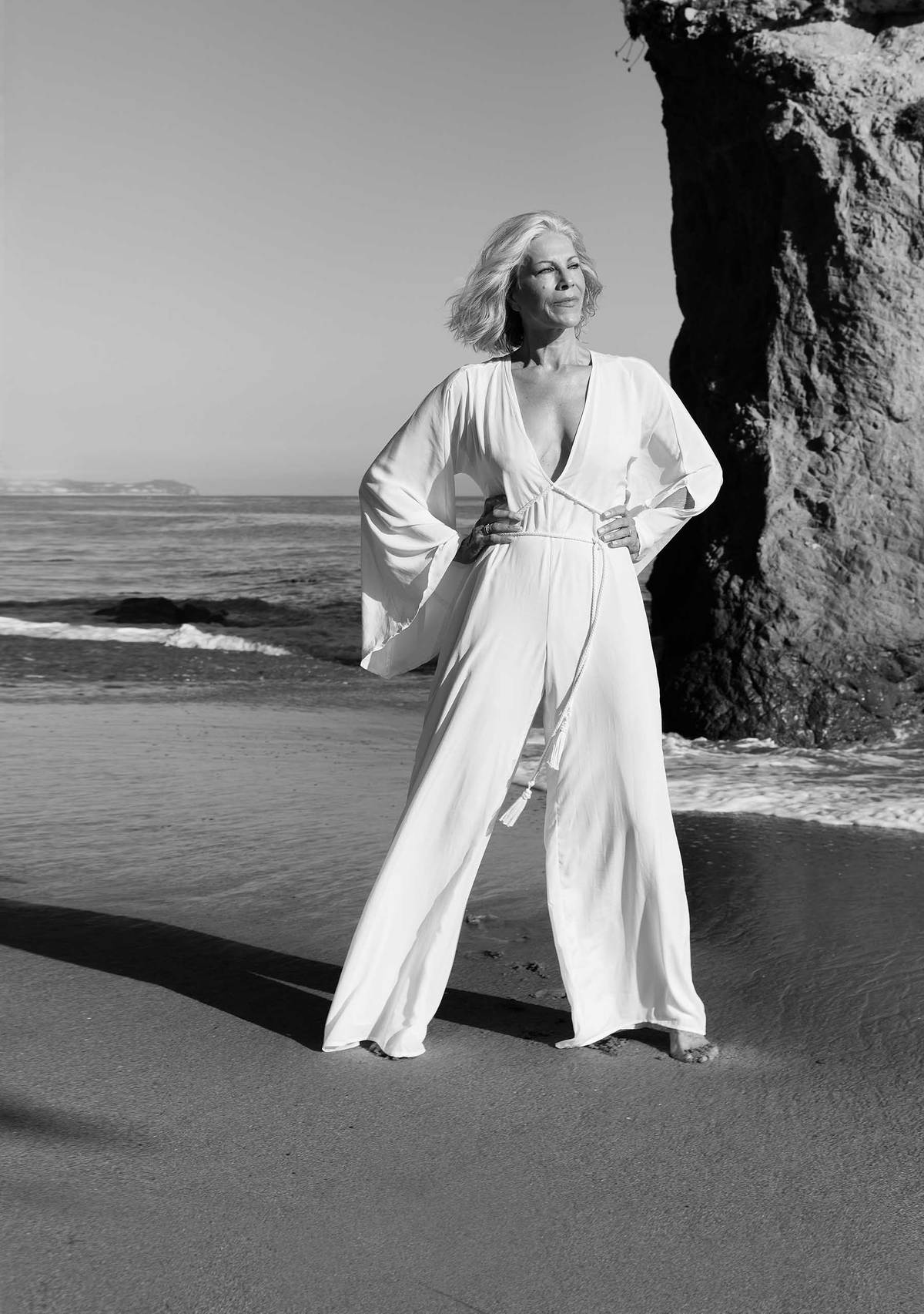 a mature woman on the beach in a confident pose