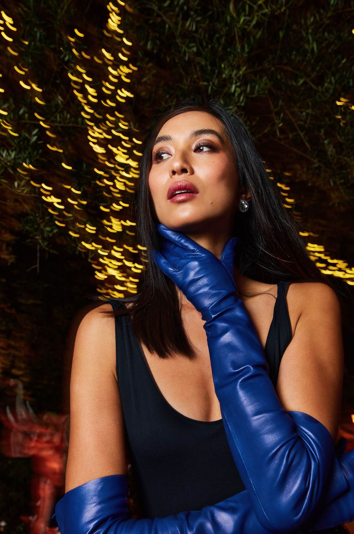 blue leather gloves worn by a model