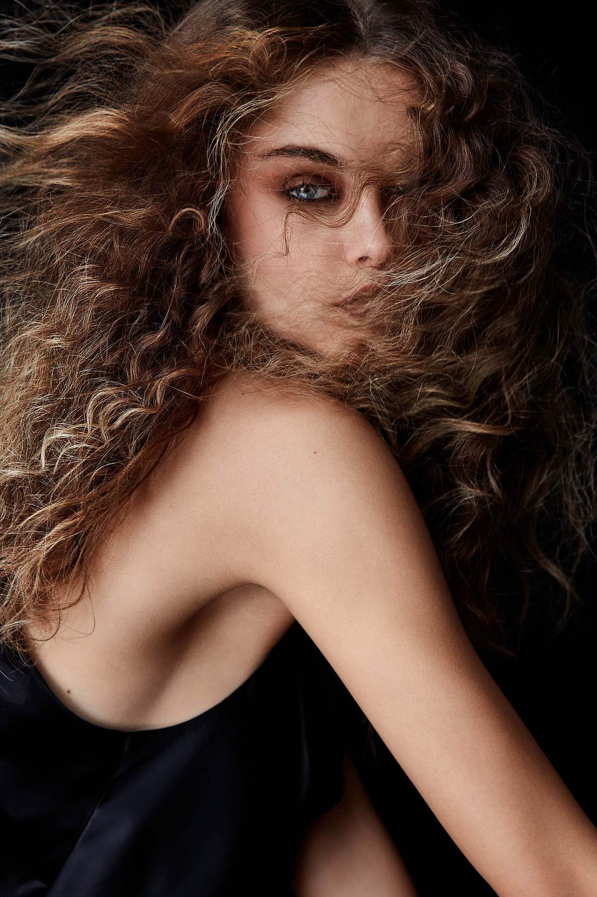 textured hair covering half of the face of the female model