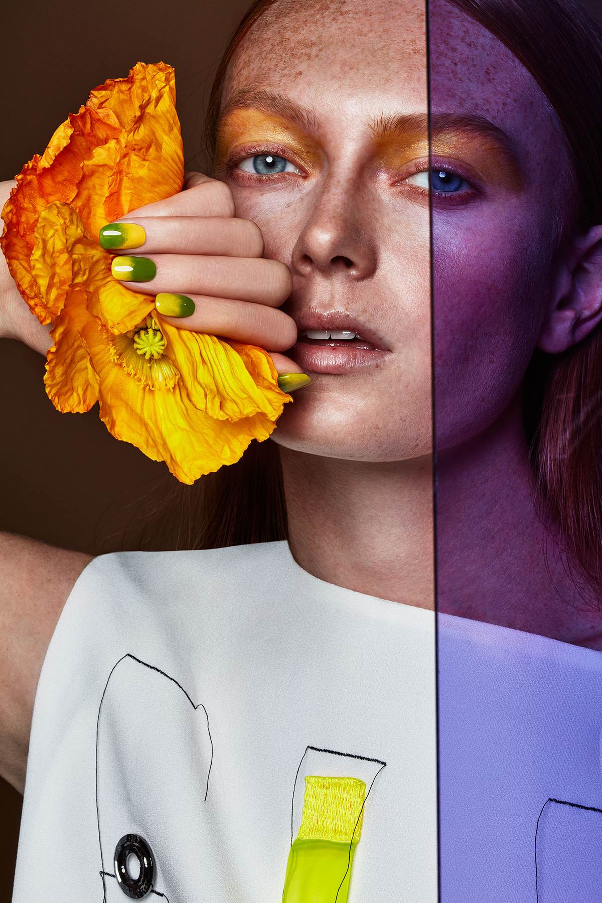 BEAUTY IMAGE WITH YELLOW/ORANGE POPPY IN THE HAND OF THE MODEL