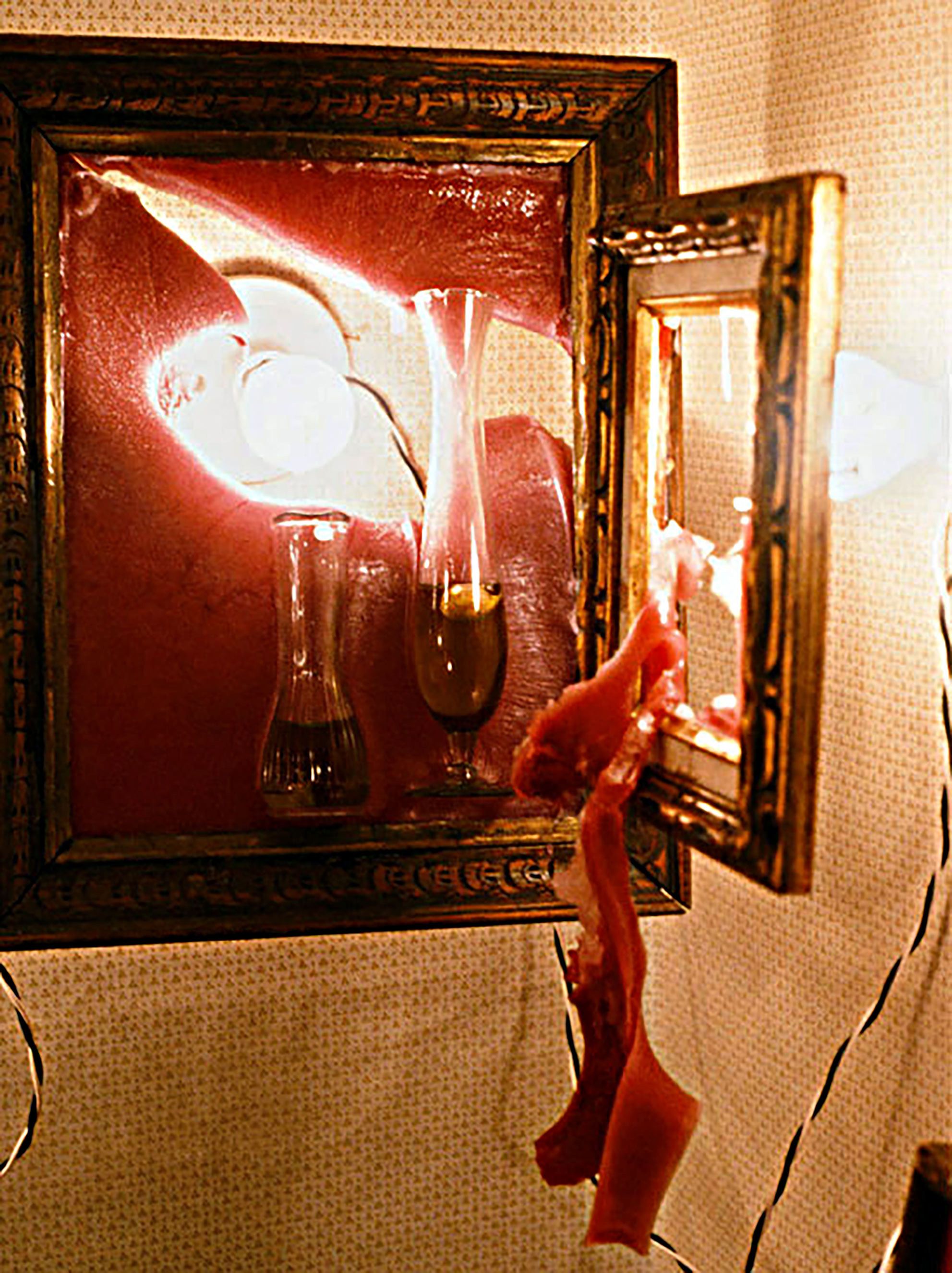 viewer activated installation of photographs oil and garlic embedded in melting wax Hall closet melting wax